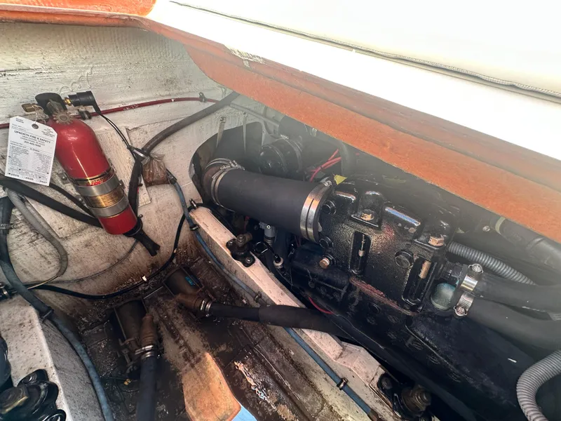 Slide: The Image of Engine compartment of a 1988 Bertram 28 Moppie with fire extinguisher and hoses. - 20