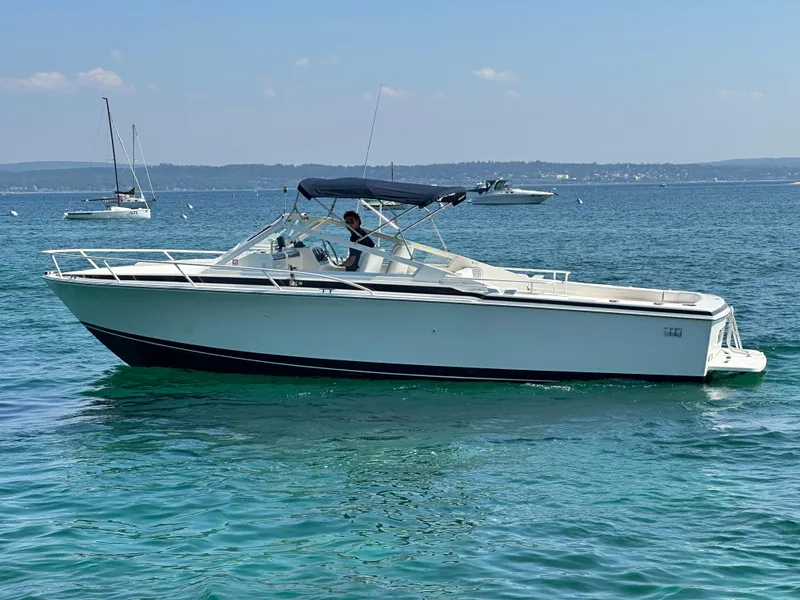 Slide: The Image of 1988 Bertram 28 Moppie boat cruising on clear blue water. - 23