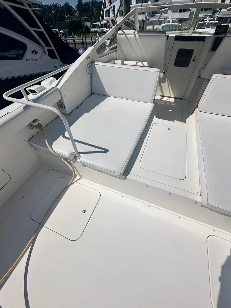 Slide: The Image of 1988 Bertram 28 Moppie boat interior with white seating and deck. - 3