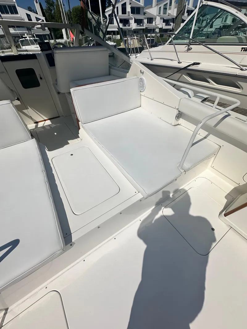 Slide: The Image of 1988 Bertram 28 Moppie boat interior with white seating and modern design. - 4