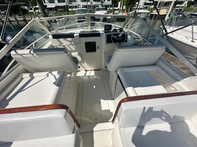 Slide: The Image of 1988 Bertram 28 Moppie boat interior with white seating and steering wheel. - 6