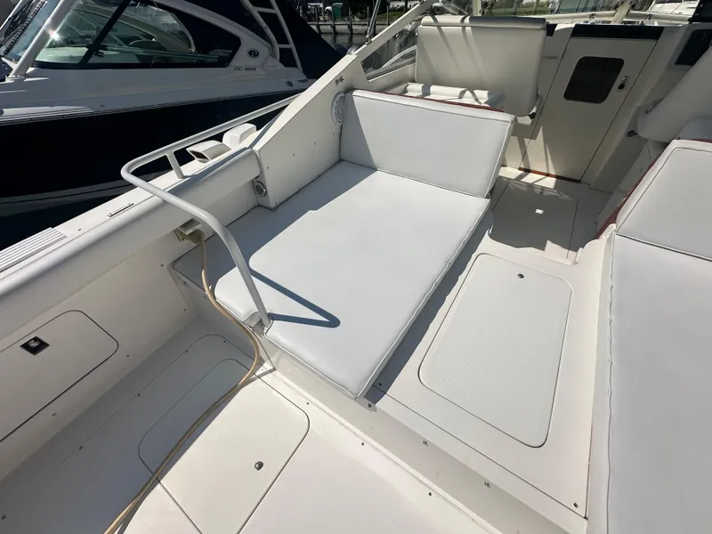 Slide: The Image of 1988 Bertram 28 Moppie boat interior with white seating and deck. - 8
