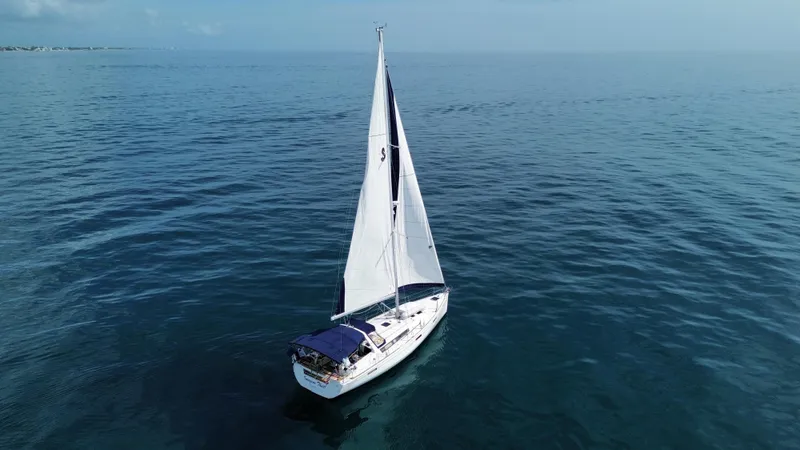 Slide: The Image of 2015 Beneteau Oceanis 45 sailing on calm blue ocean waters. - 12