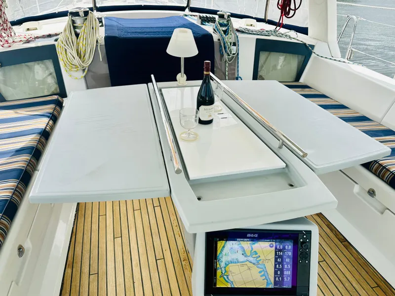Slide: The Image of Beneteau Oceanis 45 cockpit with table, wine, and navigation display, 2015 model. - 16