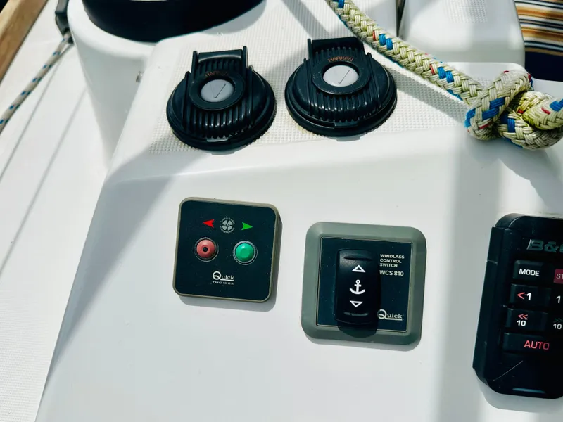 Slide: The Image of Control panel on a 2015 Beneteau Oceanis 45 sailboat, featuring winch and windlass switches. - 28