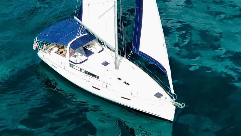 Slide: The Image of 2015 Beneteau Oceanis 45 sailing on clear blue water. - 3