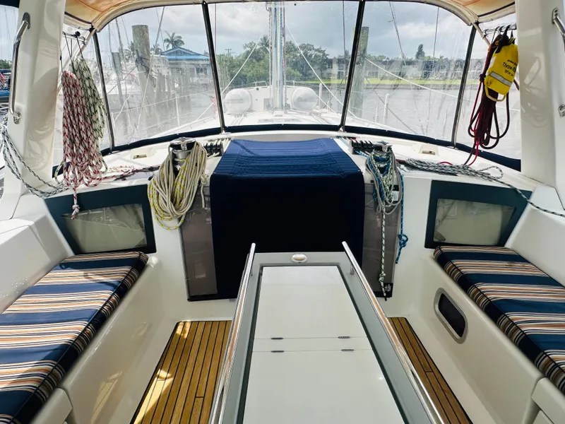 Slide: The Image of Interior view of 2015 Beneteau Oceanis 45 sailboat cockpit with striped seating and nautical ropes. - 32