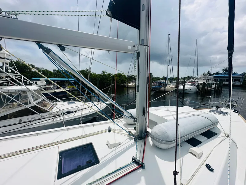 Slide: The Image of Beneteau Oceanis 45 sailboat deck, 2015 model, docked with other boats in a marina. - 37