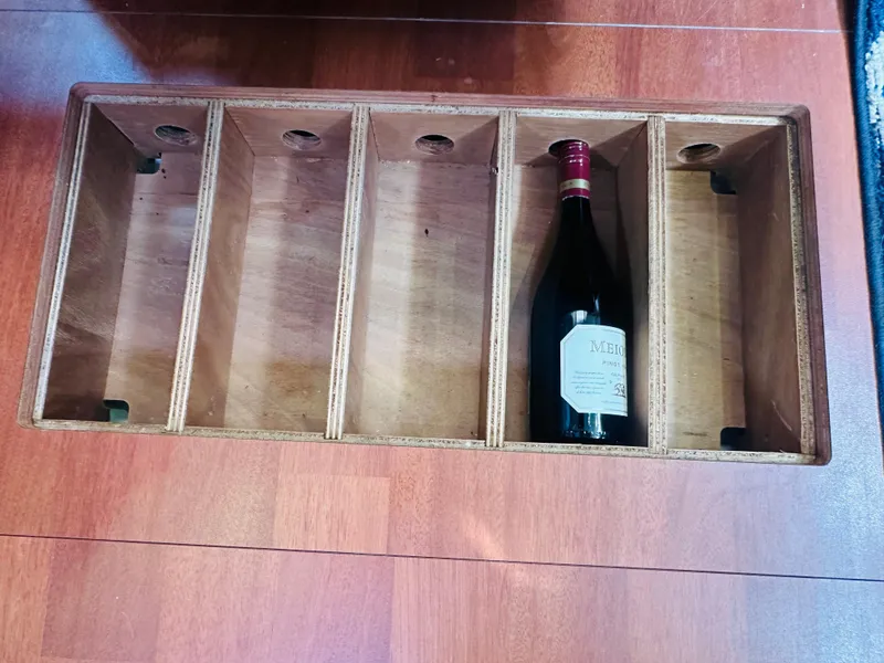 Slide: The Image of Wine storage compartment on 2015 Beneteau Oceanis 45 yacht, featuring a single wine bottle. - 44