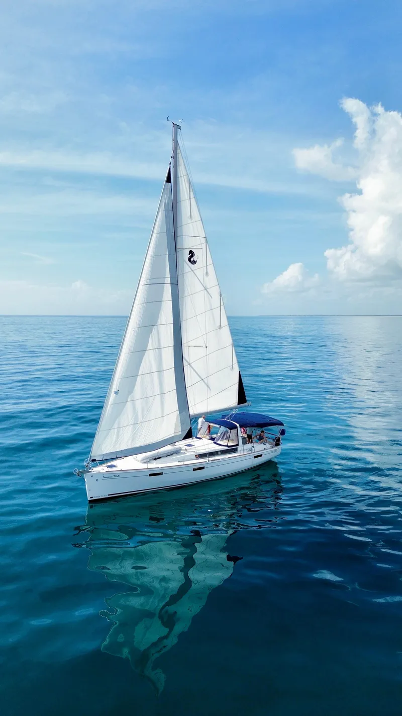 Slide: The Image of Beneteau Oceanis 45 sailboat from 2015 on calm blue ocean under clear sky. - 8