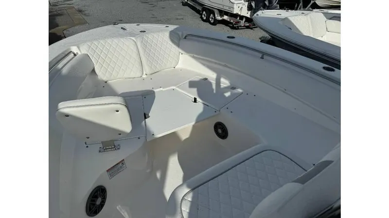 Slide: The Image of 2026 Sea Fox 248 Side Console boat interior with white seating and table. - 10