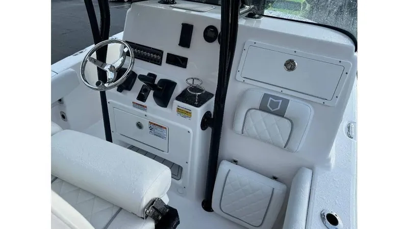 Slide: The Image of 2026 Sea Fox 248 Side Console boat interior with steering wheel and control panel. - 4