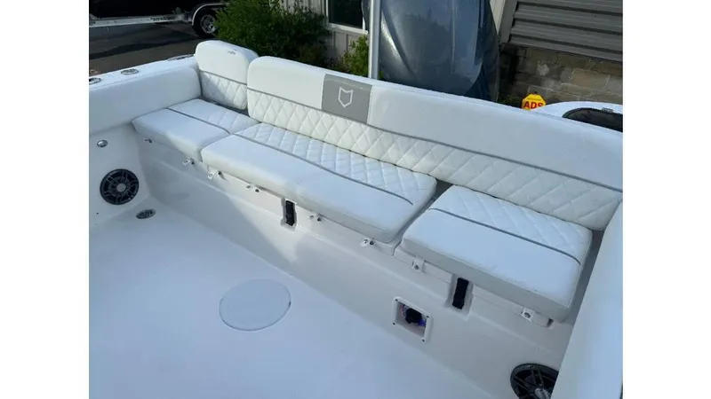 Slide: The Image of 2026 Sea Fox 248 Side Console boat with white cushioned seating and speaker system. - 6