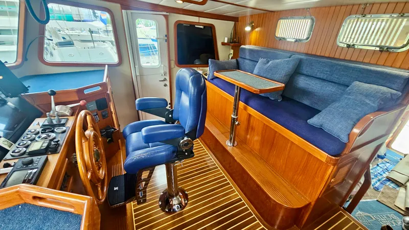 Slide: The Image of Luxurious interior of 2008 Kadey-Krogen 44 yacht with blue leather chairs and wooden accents. - 10