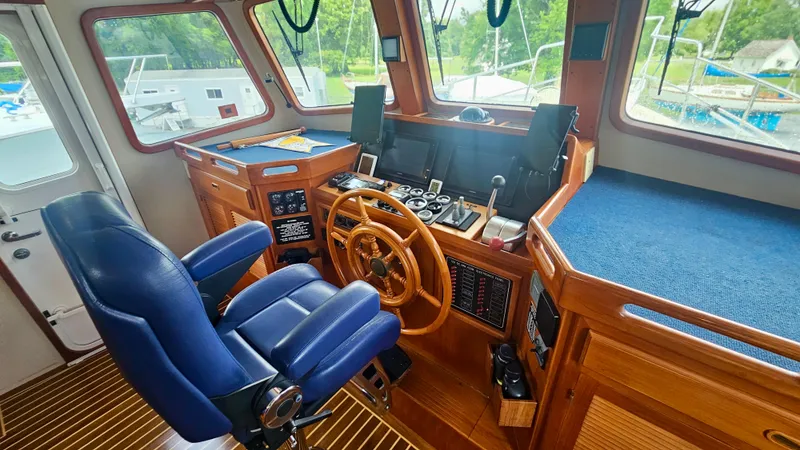 Slide: The Image of Cozy interior of 2008 Kadey-Krogen 44 yacht with dining area and wooden table. - 12