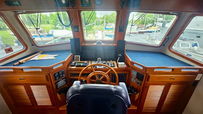 Slide: The Image of Interior of 2008 Kadey-Krogen 44 yacht with mounted TV and wooden cabinetry. - 16