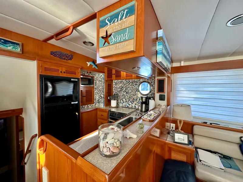 Slide: The Image of Luxurious 2008 Kadey-Krogen 44 yacht interior with kitchen, seating area, and elegant decor. - 17