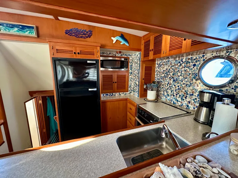 Slide: The Image of Cozy 2008 Kadey-Krogen 44 yacht kitchen with mosaic backsplash, wooden cabinets, and modern appliances. - 18
