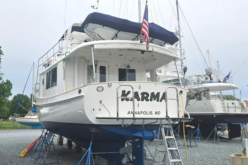 Slide: The Image of 2008 Kadey-Krogen 44 yacht docked in a marina with American flag. - 2