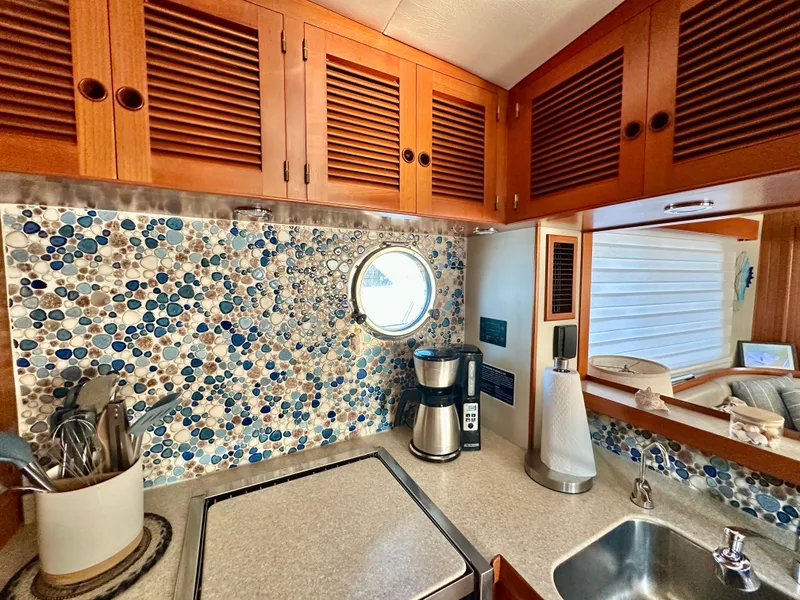 Slide: The Image of Cozy Kadey-Krogen 44 yacht kitchen with mosaic backsplash and wooden cabinets, 2008 model. - 21