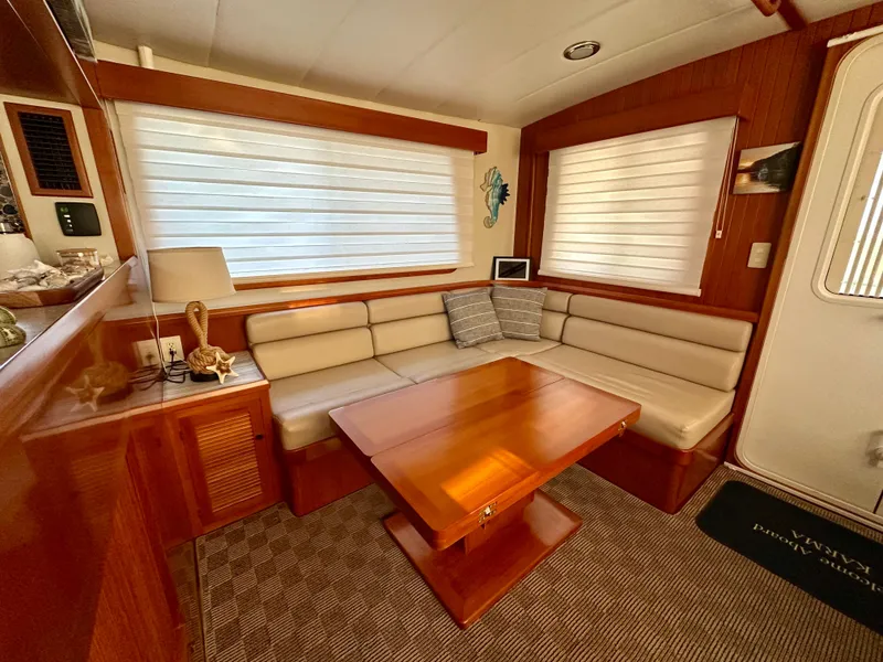 Slide: The Image of Pilothouse interior of 2008 Kadey-Krogen 44 yacht with wooden flooring and blue seating. - 24