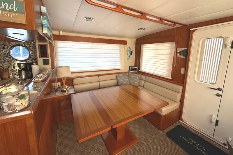 Slide: The Image of Pilothouse interior of 2008 Kadey-Krogen 44 yacht with blue captain's chair and wooden steering wheel. - 27