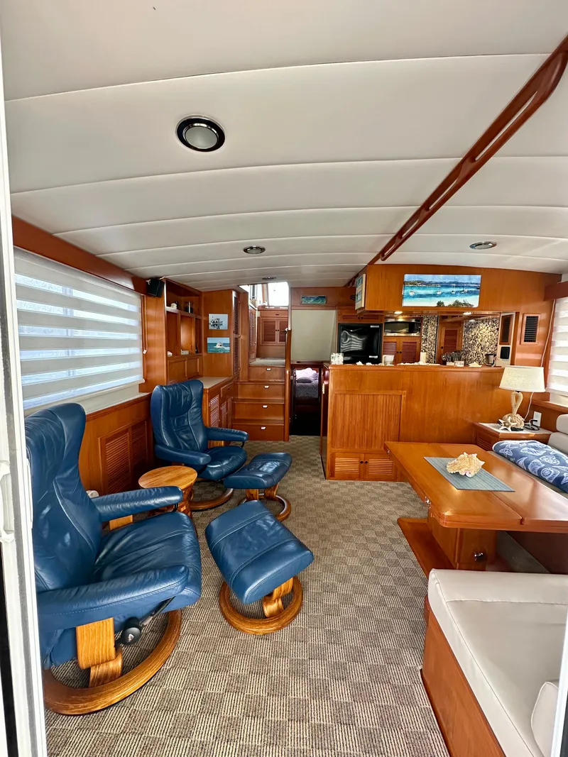Slide: The Image of Pilothouse interior of 2008 Kadey-Krogen 44 with wooden flooring and blue captain's chair. - 28