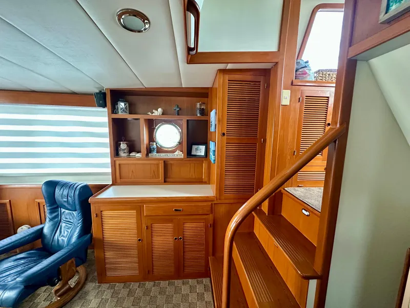 Slide: The Image of 2008 Kadey-Krogen 44 interior with blue seating, wooden flooring, and adjustable table. - 31