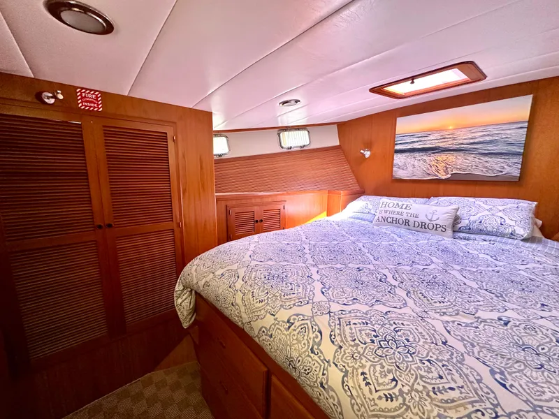 Slide: The Image of Cozy interior of 2008 Kadey-Krogen 44 yacht with blue sofa and wooden cabinetry. - 38