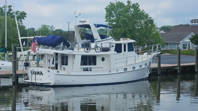 Slide: The Image of Luxurious 2008 Kadey-Krogen 44 yacht interior with blue chairs and wooden cabinetry. - 4