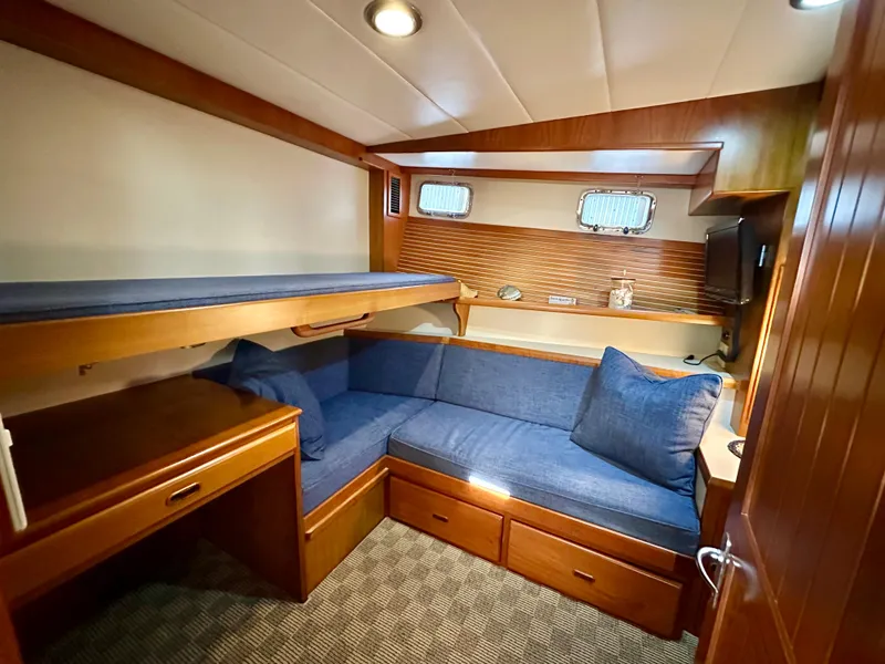 Slide: The Image of Cozy interior of 2008 Kadey-Krogen 44 yacht with wooden shelves and blue seating. - 42