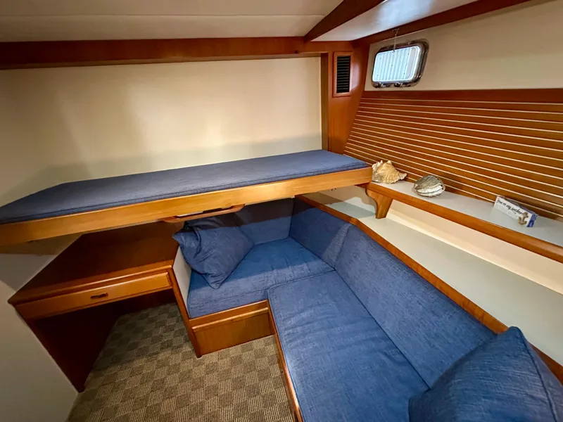 Slide: The Image of Cozy interior of 2008 Kadey-Krogen 44 yacht with wooden cabinetry and soft lighting. - 43