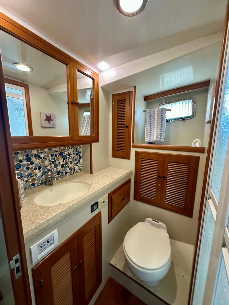 Slide: The Image of 2008 Kadey-Krogen 44 interior with laundry area and cozy bedroom. - 48