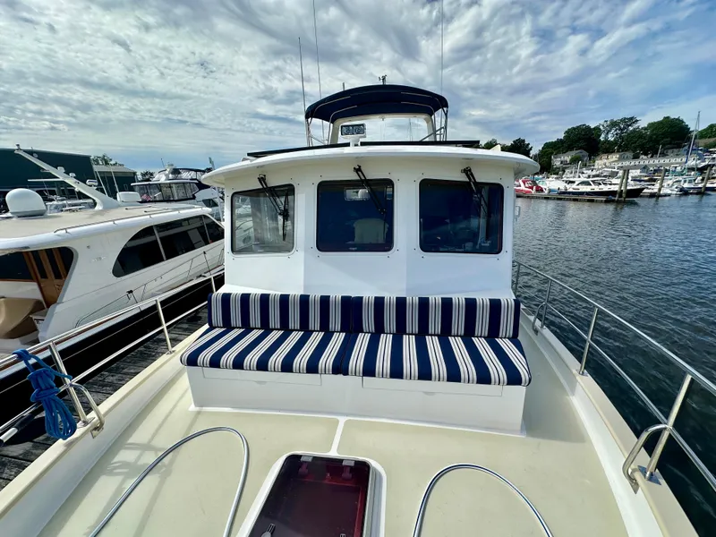 Slide: The Image of 2008 Kadey-Krogen 44 yacht docked, showcasing side deck and cabin door. - 61
