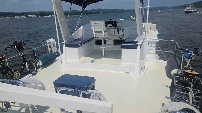 Slide: The Image of 2008 Kadey-Krogen 44 yacht deck with seating, helm, and marina view. - 64