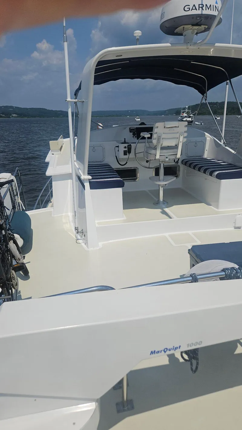 Slide: The Image of 2008 Kadey-Krogen 44 yacht docked at marina with cityscape background. - 65