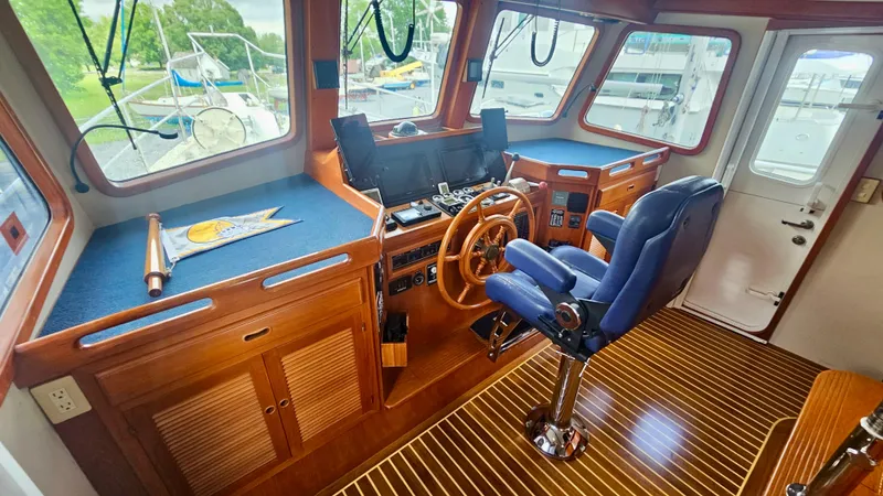 Slide: The Image of Luxurious interior of 2008 Kadey-Krogen 44 yacht with leather chairs and wooden cabinetry. - 8