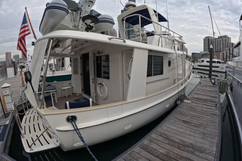 Slide: The Image of Kadey-Krogen 44 yacht, 2008 model, docked at marina with cityscape background. - 80