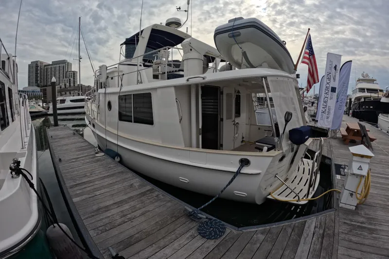 Slide: The Image of 2008 Kadey-Krogen 44 yacht docked at marina under cloudy sky. - 81