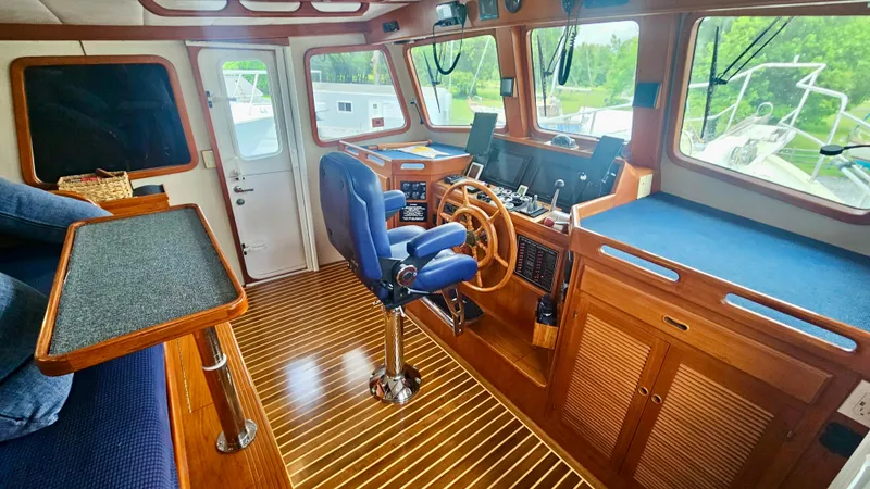 Slide: The Image of Interior of 2008 Kadey-Krogen 44 yacht with wooden cabinetry and blue leather chair. - 9