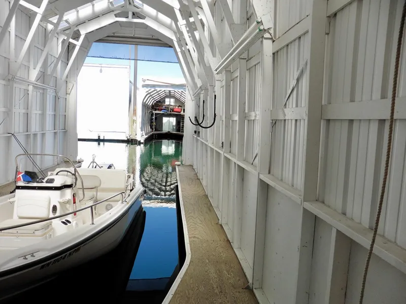 Slide: The Image of White boathouse interior with docked boat, Custom Boathouse #A138, 2012 model. - 11
