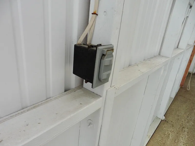 Slide: The Image of Outdoor electrical outlet on white wooden wall, Custom Boathouse #A138, 2012. - 7