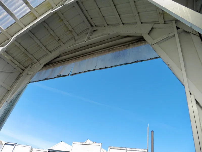 Slide: The Image of Open roof of Custom Boathouse #A138, 2012, against clear blue sky. - 9