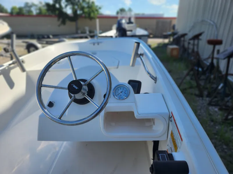 Slide: The Image of 2011 Boston Whaler 130 Super Sport boat steering wheel and dashboard close-up. - 5