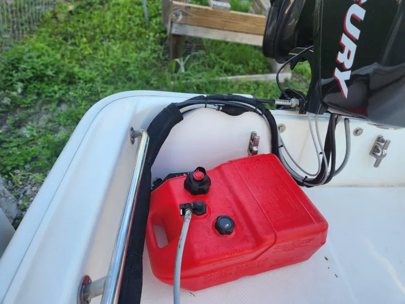 Slide: The Image of 2011 Boston Whaler 130 Super Sport with red fuel tank and Mercury engine. - 8