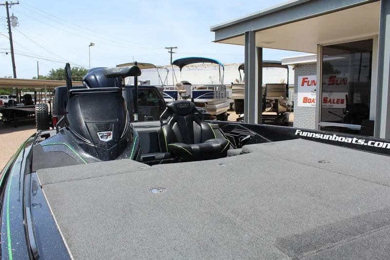 Slide: The Image of 2020 Skeeter FXR21 boat at dealership, showcasing spacious deck and seating. - 10