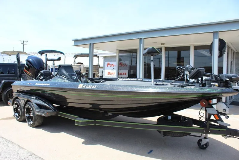 Slide: The Image of 2020 Skeeter FXR21 bass boat on trailer, parked outside dealership. - 11