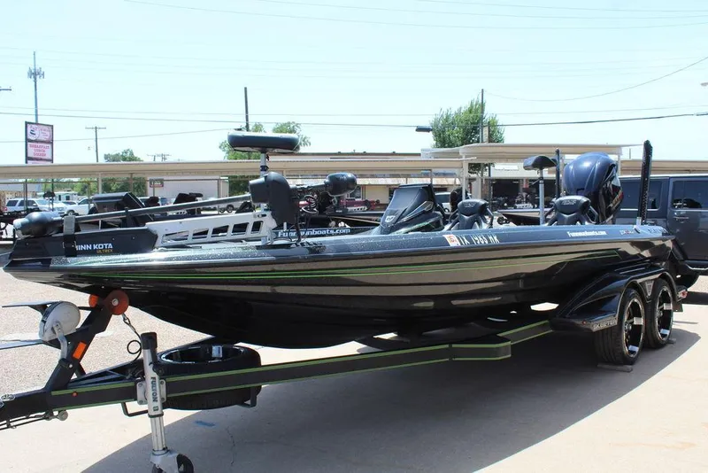Slide: The Image of 2020 Skeeter FXR21 bass boat on trailer, equipped with Minn Kota trolling motor. - 12