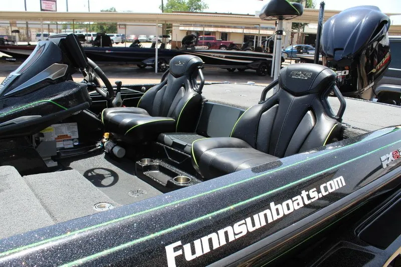 Slide: The Image of 2020 Skeeter FXR21 boat interior with sleek black seats and modern dashboard. - 13