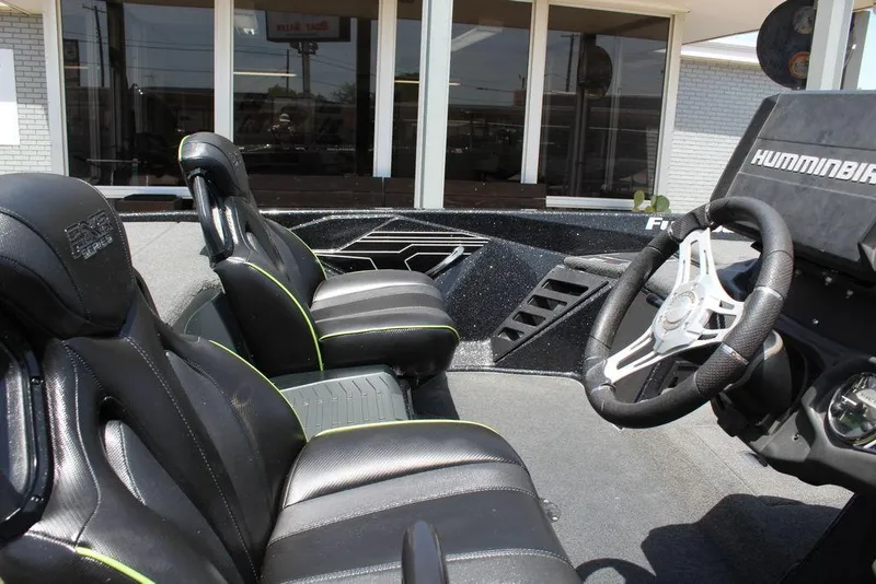 Slide: The Image of 2020 Skeeter FXR21 boat interior with black seats and steering wheel. - 14